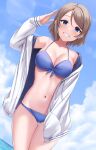  1girl absurdres bikini blue_bikini blue_eyes blue_sky breasts cleavage cloud cowboy_shot dutch_angle front-tie_bikini front-tie_top grin hand_in_pocket hand_up highres light_brown_hair looking_at_viewer love_live! love_live!_sunshine!! medium_breasts navel rama_(yu-light8) salute short_hair sky smile solo stomach sweater swimsuit thigh_gap watanabe_you water white_sweater 