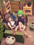  2girls animal_ears bangs barefoot black_jacket book bookshelf breasts brown_hair cat_ears cat_girl cellphone cleavage coffee couch cup erodozer handheld_game_console highres holding holding_handheld_game_console ichika_maia indie_virtual_youtuber jacket long_hair lying medium_breasts multiple_girls nintendo_switch on_couch phone playstation_controller purple_eyes sitting smartphone smile tank_top virtual_youtuber white_tank_top yuukina_(vtuber) 