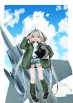  1girl absurdres aircraft airplane ao_(greburi) belt black_belt black_footwear blonde_hair boots border brown_hair cloud denim denim_shorts fighter_jet green_jacket grey_hair headwear_removed helmet helmet_removed highres holding holding_helmet jacket jet jewelry long_hair military military_vehicle multicolored_hair necklace original outside_border salute shorts sky smile solo streaked_hair tube_socks very_long_hair white_border 