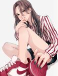  1girl black_nails blue_eyes brown_hair closed_mouth fingernails foreshortening highres long_hair long_sleeves looking_at_viewer nail_polish original red_footwear shirt shoes simple_background sitting smile solo striped striped_shirt tsunko_(9v2_q) white_background 