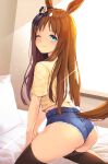  1girl ;) animal_ears ass backlighting black_legwear bloody0rabby blue_shorts blush brown_hair closed_mouth commentary_request grass_wonder_(umamusume) highres horse_ears horse_girl horse_tail indoors long_hair looking_at_viewer looking_back on_bed one_eye_closed pillow shirt short_shorts short_sleeves shorts smile solo sunlight sweat tail thighhighs umamusume very_long_hair window yellow_shirt 