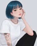  1girl arm_tattoo bangs blue_hair brown_eyes ear_piercing earrings grey_background head_rest highres jewelry lips looking_at_viewer necklace original piercing ring shirt short_hair sitting solo t-shirt tattoo umigraphics 