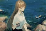 1girl 7ife absurdres bangs brown_eyes brown_hair closed_mouth collared_shirt commentary day english_commentary highres holding holding_shell long_hair looking_at_viewer ocean original outdoors school_uniform shell shirt short_sleeves solo upper_body white_shirt 