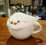  animal animal_focus coffee commentary_request cup drink fish full_body george_(yamamoto_kazuki) latte_art latte_art_(medium) no_humans original photo_(medium) sacabambaspis solo triangle_mouth unconventional_media 