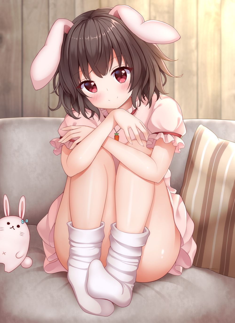 1girl animal animal_ears ass black_hair blush carrot_necklace closed_mouth commentary_request couch dress frilled_sleeves frills hair_between_eyes highres inaba_tewi jewelry looking_at_viewer necklace pink_dress rabbit rabbit_ears red_eyes short_hair short_sleeves smile socks solo suigetsu_(watermoon-910) touhou white_socks
