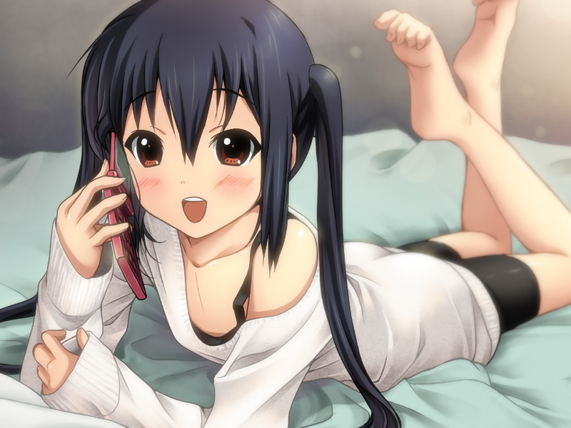 barefoot bed bike_shorts black_hair blush brown_eyes cellphone feet k-on! long_hair lying nakano_azusa off_shoulder on_stomach phone ryunnu sleeves_past_wrists smile solo sweater twintails