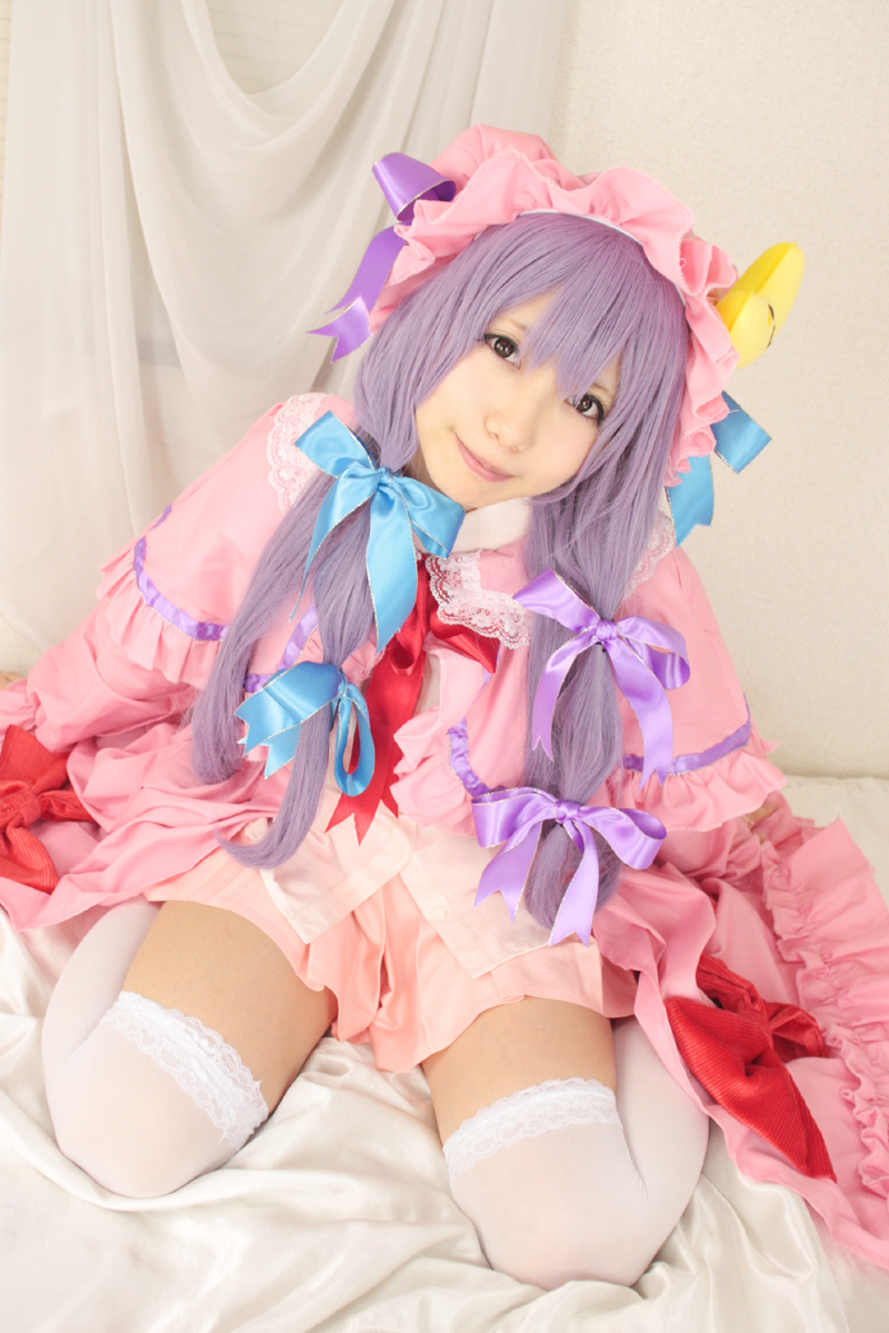 1girl asian bed cosplay crescent dress female hat long_hair patchouli_knowledge photo pillow purple_hair solo tenshi_myu touhou