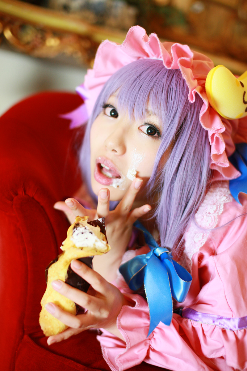 1girl asian cosplay couch cream crescent dessert dress female food hat highres long_hair patchouli_knowledge photo purple_hair solo tenshi_myu touhou