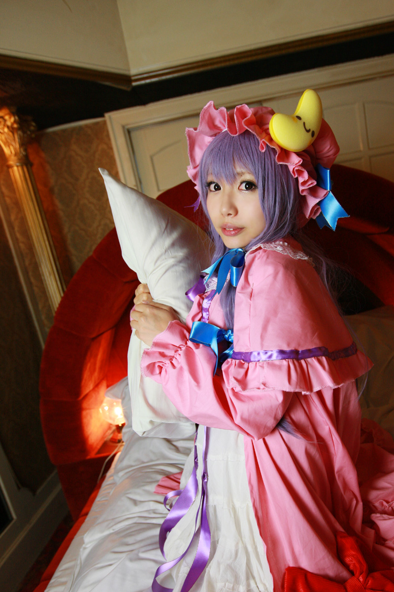 1girl asian bed blanket cosplay crescent dress female hat highres long_hair patchouli_knowledge photo pillow purple_hair solo tenshi_myu touhou