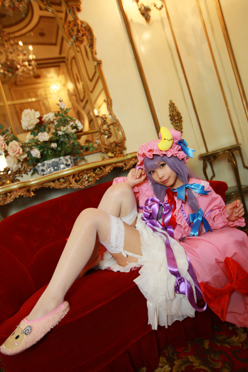 1girl asian cosplay couch crescent dress female hat highres long_hair patchouli_knowledge photo purple_hair solo tenshi_myu touhou