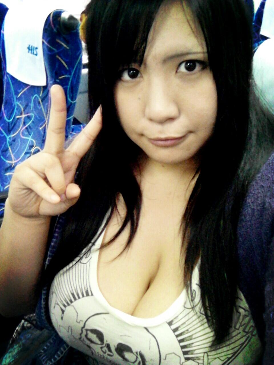 1girl airplane asian black_hair breasts chouzuki_maryou jacket large_breasts photo seat skull solo t-shirt towel v