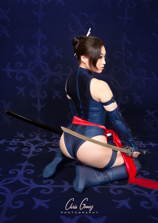 1girl ass high_heels katana kneeling long_boots marvel photo psylocke short_hair solo sword weapon x-men yaya_han