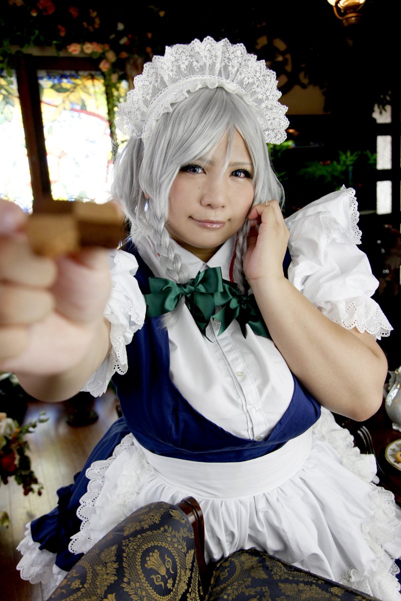 apron big_breasts blue_eyes braid breasts chouzuki_maryou cookie cosplay food izayoi_sakuya izayoi_sakuya_(cosplay) large_breasts maid maid_apron maid_headdress photo plump short_hair short_sleeves silver_hair solo touhou twin_braids