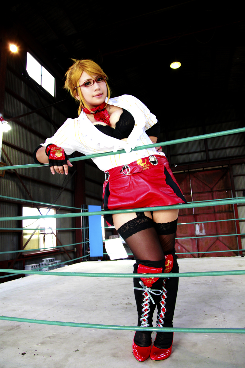 1girl asian blonde_hair blue_eyes boxing_ring breasts chouzuki_maryou cosplay fingerless_gloves glasses gloves large_breasts miss_spencer miss_spencer_(cosplay) photo rumble_roses rumble_roses_xx solo