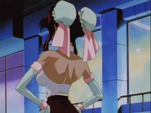 1girl 90s animated animated_gif bare_shoulders bounce bouncing_breasts breasts brooch brown_hair burn-up burn-up_w center_opening cleavage dark_skin detached_collar detached_sleeves female halter_top hands_on_hips jewelry large_breasts nanvel_candlestick no_bra oldschool outdoors ribbon shorts solo talking upper_body