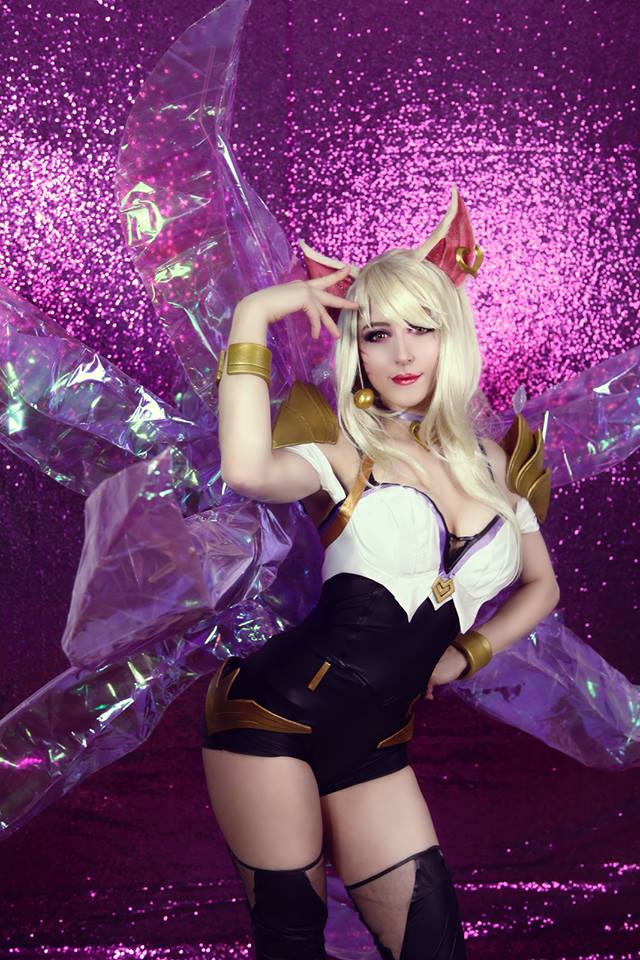 ahri animal_ears animal_tail blonde_hair breasts cleavage cosplay fox fox_ears fox_tail league_of_legends long_hair looking_at_viewer makeup mowky solo stockings tail thighhighs