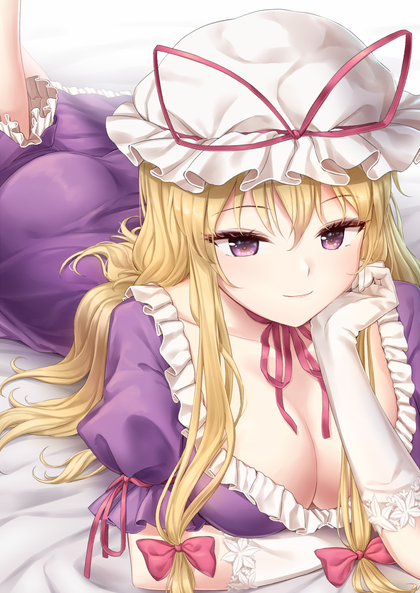 1girl arm_ribbon ass bangs bed_sheet blonde_hair bow breasts choker cleavage collarbone commentary_request dress eyebrows_visible_through_hair eyelashes feet_out_of_frame frills gloves hair_between_eyes hair_bow hand_up hat hat_ribbon head_rest highres large_breasts long_hair looking_at_viewer lying minust mob_cap on_stomach petticoat puffy_short_sleeves puffy_sleeves purple_dress purple_eyes red_bow red_choker red_ribbon ribbon ribbon_choker short_sleeves sidelocks smile solo touhou white_gloves white_headwear yakumo_yukari