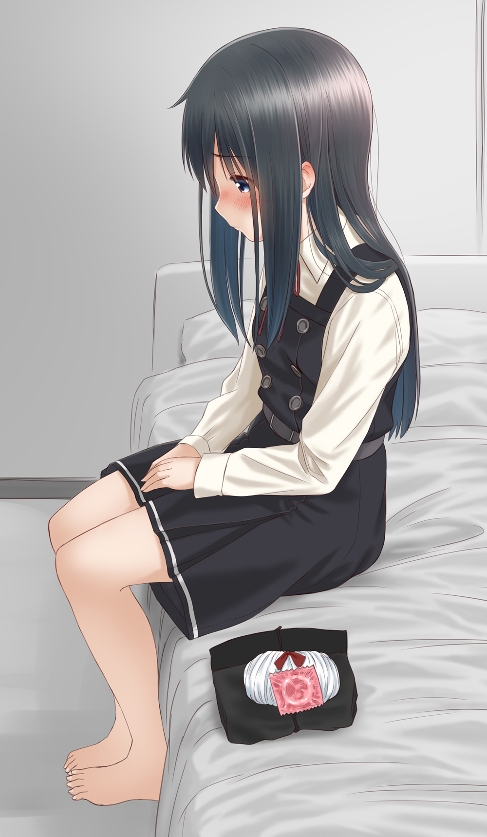 1girl asashio_(kantai_collection) bangs barefoot black_dress black_hair blue_eyes blush buttons closed_mouth collared_shirt commentary_request condom_wrapper dress eyebrows_visible_through_hair from_side hands_together highres indoors kantai_collection long_hair long_sleeves on_bed red_ribbon retsumaru ribbon shiny shiny_hair shirt sidelocks sitting solo toes white_shirt