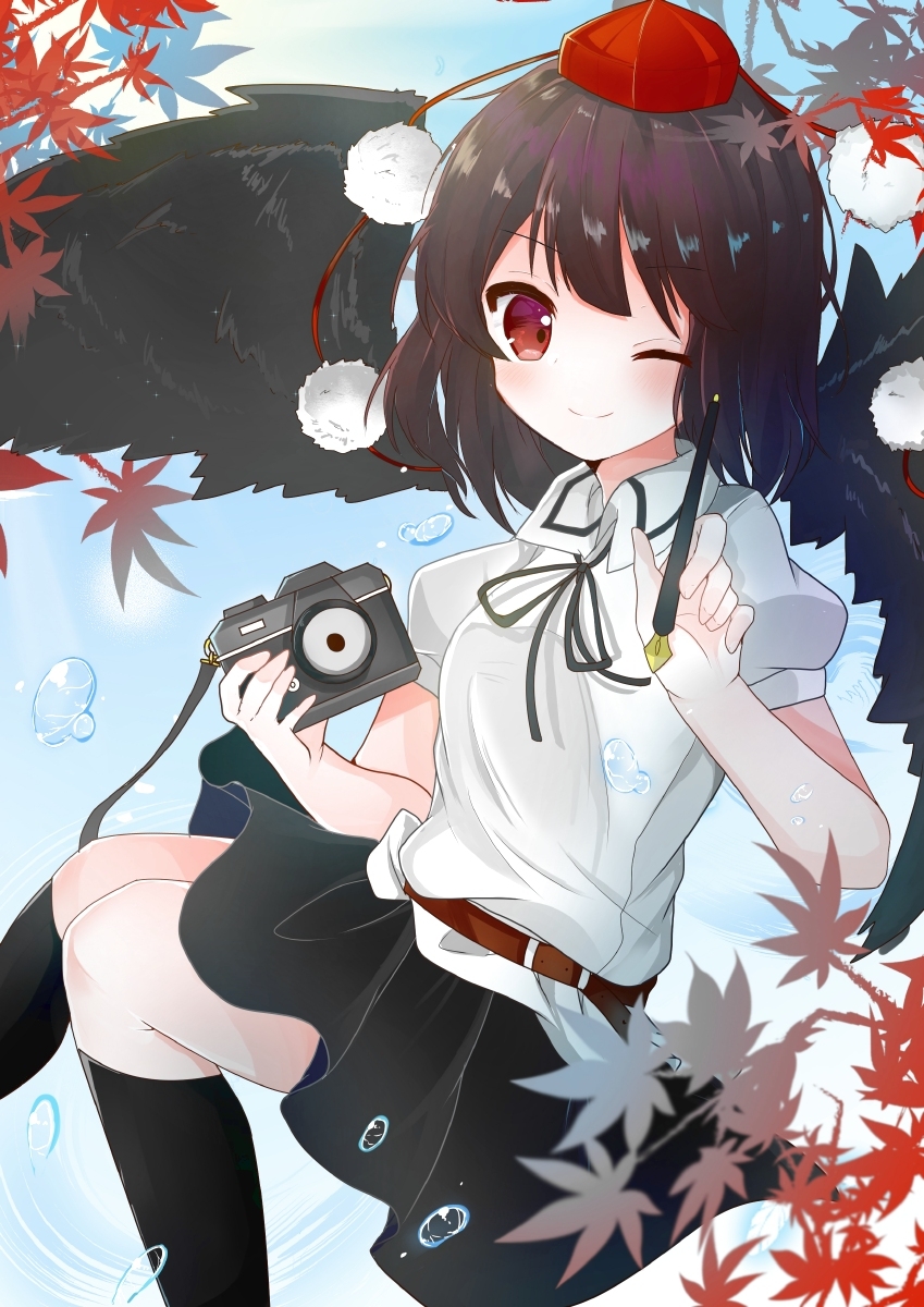 1girl autumn_leaves bangs bird_wings black_hair black_legwear black_neckwear black_ribbon black_skirt black_wings blush bubble camera closed_mouth collared_shirt disconnected_mouth doko_ka_no_hosono eyebrows_visible_through_hair feet_out_of_frame fountain_pen hat highres holding holding_camera holding_pen kneehighs leaf looking_at_viewer medium_hair neck_ribbon pen pom_pom_(clothes) red_eyes ribbon shameimaru_aya shirt skirt smile solo tokin_hat touhou white_shirt wings