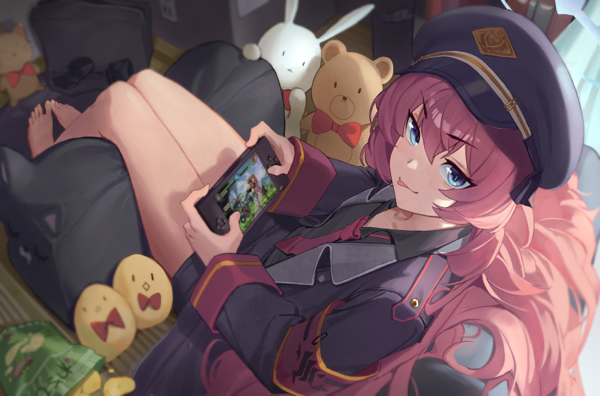 1girl :p absurdres armband bag_of_chips barefoot blue_archive chips coat food handheld_game_console hat highres indoors iroha_(blue_archive) jacket jaws_(okdol0928) military military_hat military_jacket military_uniform necktie open_clothes open_jacket peaked_cap playing_games potato_chips red_hair red_necktie safety_pin sitting snack solo stuffed_animal stuffed_bunny stuffed_toy teddy_bear tongue tongue_out uniform