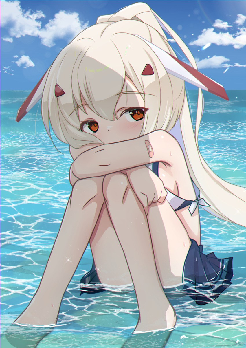 1girl arm_support armpits ass ayanami_(azur_lane) azur_lane bandaid bandaid_on_arm bangs barefoot bent_over blue_skirt blue_sky breasts cloud cloudy_sky commentary_request covered_mouth hair_between_eyes hair_ornament hairclip head_tilt headgear highres horizon hugging_own_legs in_water knees_to_chest knees_together_feet_apart light_brown_hair long_hair looking_at_viewer midriff ocean orange_eyes oruk pleated_skirt ponytail retrofit_(azur_lane) school_uniform serafuku sideboob sidelocks skirt sky sleeveless solo wet wet_clothes
