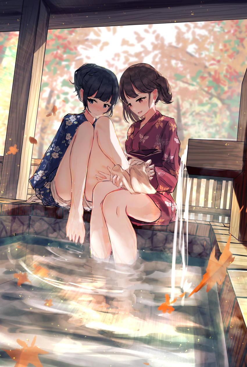 2girls absurdres ashiyu autumn_leaves barefoot benevole black_hair blue_eyes blue_kimono blurry blurry_background blush breasts brown_eyes brown_hair closed_mouth commentary_request embarrassed floral_print foot_bath hair_bun highres japanese_clothes kimono multiple_girls obi open_mouth original red_kimono sash shorts small_breasts soaking_feet towel tree water wavy_mouth wet white_shorts yukata yuri