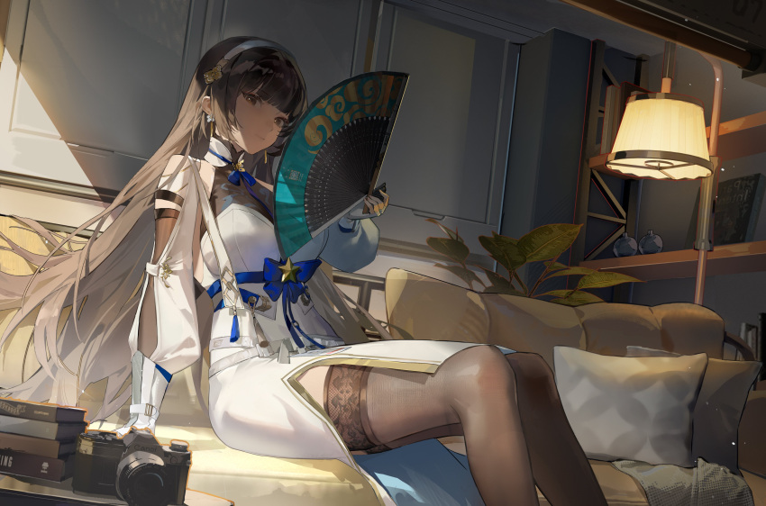 1girl absurdres black_thighhighs blue_bow book book_stack bookshelf bow brand_name_imitation breasts brown_hair camera chinese_clothes coach folding_fan girls'_frontline girls'_frontline_2:_exilium hand_fan highres holding holding_fan jiojio lamp long_hair looking_at_viewer orange_eyes pillow sitting solo thighhighs type_95_(girls'_frontline) vegetation