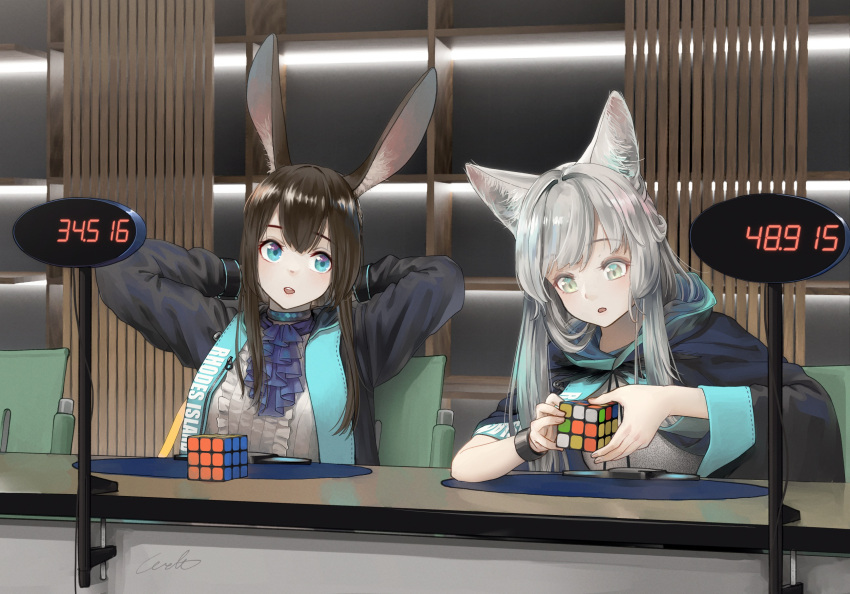 2girls amiya_(arknights) animal_ears arknights arms_behind_head ascot black_bracelet black_cape black_jacket blue_ascot blue_collar blue_eyes brown_hair cape cat_ears cat_girl clothes_writing collar green_eyes grey_hair highres holding_cube indoors jacket jewelry long_sleeves multiple_girls neck_ring open_clothes open_jacket open_mouth rabbit_ears rabbit_girl rosmontis_(arknights) rubik's_cube shirt timer upper_body welt_(kinsei_koutenkyoku) white_shirt