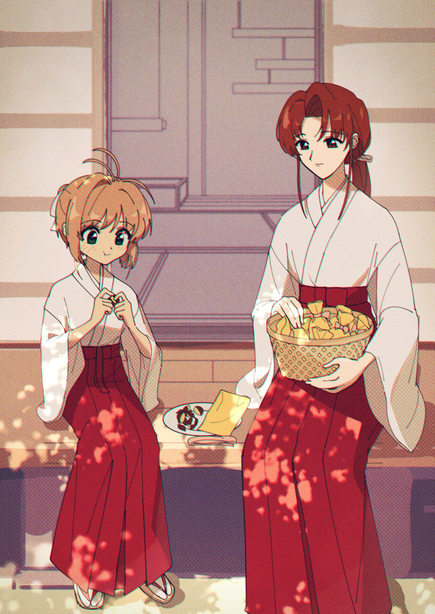 2girls absurdres basket brown_eyes brown_hair cardcaptor_sakura green_eyes hakama highres japanese_clothes kinomoto_sakura long_hair low_ponytail miko mizuki_kaho multiple_girls nzeneee red_hakama sandals short_hair sitting sliding_doors tatami veranda