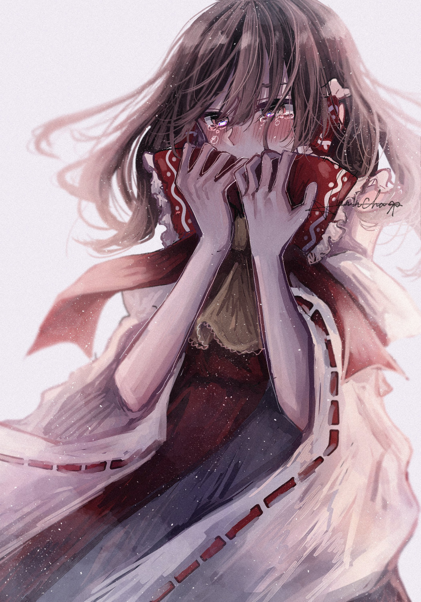 1girl absurdres annin_cha ascot blush bow brown_eyes covering_mouth crying detached_sleeves frilled_bow frilled_hair_tubes frills hair_bow hair_tubes hakurei_reimu highres japanese_clothes long_hair miko nontraditional_miko red_bow ribbon_trim simple_background skirt skirt_set solo tears touhou white_background wide_sleeves yellow_ascot