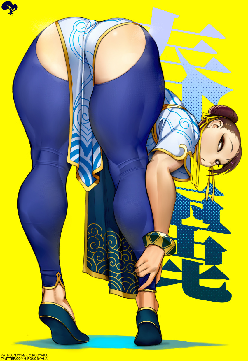 1girl absurdres ass background_text bent_over black_footwear blue_pants brown_eyes brown_hair character_name china_dress chinese_clothes chinese_text chun-li double_bun dress earrings eyeliner flats flexible from_behind full_body hair_bun hair_pulled_back hair_ribbon highres jewelry kneepits krokobyaka looking_back makeup non-web_source pants pearl_earrings pelvic_curtain ribbon short_hair simple_background solo standing street_fighter street_fighter_6 thick_thighs thighs tight tight_pants tiptoes yellow_background