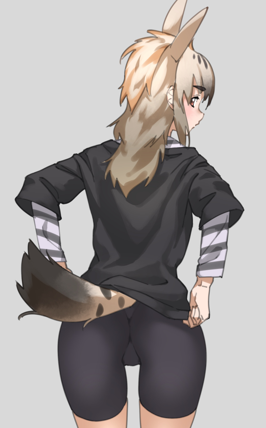 1girl absurdres animal_ears bike_shorts black_shirt blonde_hair brown_eyes commentary extra_ears from_behind grey_background highres kemono_friends layered_sleeves light_brown_hair long_hair long_sleeves looking_back shirt short_over_long_sleeves short_sleeves simple_background solo spotted_hyena_(kemono_friends) striped_sleeves tail tanabe_(fueisei)