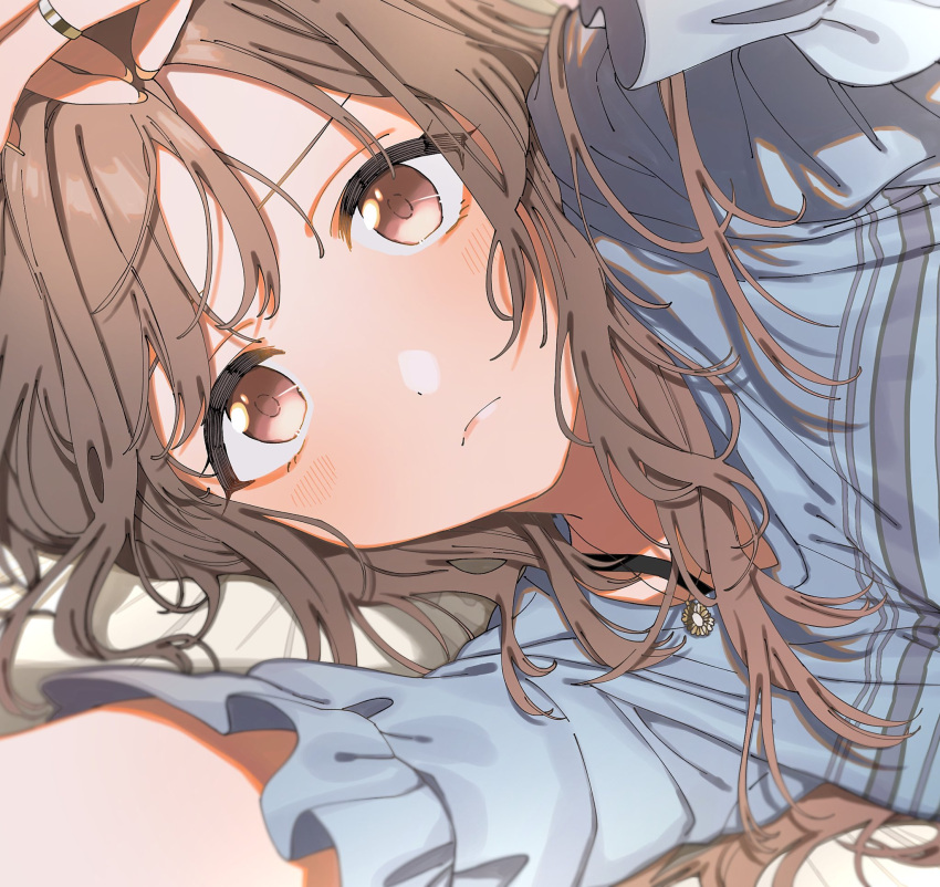 1girl blue_shirt blush bra_strap brown_eyes brown_hair eyes_visible_through_hair hand_on_own_head highres idolmaster idolmaster_shiny_colors iwawa jewelry long_hair looking_at_viewer lying pendant shirt solo tsukioka_kogane