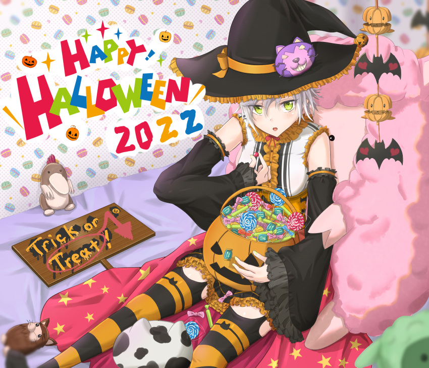 1girl bat_(animal) bed blush candy cosplay detached_sleeves eiyuu_densetsu fie_claussell food green_eyes hat highres jack-o'-lantern lollipop sen_no_kiseki short_hair sitting solo stuffed_animal stuffed_toy thighhighs white_hair witch witch_f witch_hat