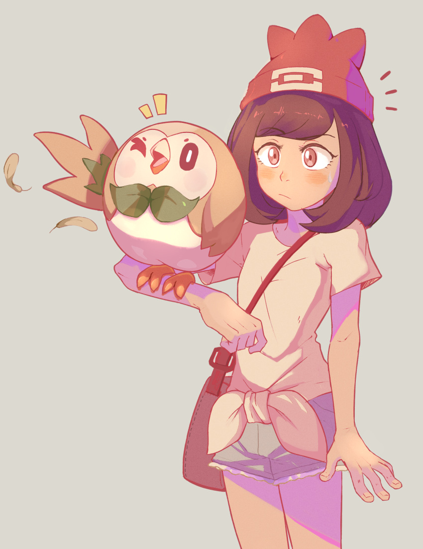 1girl absurdres bag bangs beanie bird blush brown_bag brown_hair closed_mouth feathers green_shorts hat highres medium_hair notice_lines pokemon pokemon_(creature) pokemon_(game) pokemon_on_arm pokemon_sm red_headwear rowlet sally_(luna-arts) selene_(pokemon) shirt short_shorts short_sleeves shorts shoulder_bag t-shirt tied_shirt