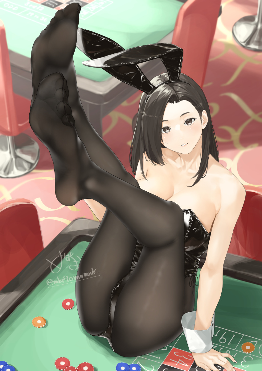 1girl absurdres animal_ears bare_arms bare_shoulders black_eyes black_hair black_leotard black_pantyhose casino covered_navel fake_animal_ears feet feet_up highres leg_up leotard looking_at_viewer mbr90munouk on_table original pantyhose playboy_bunny poker_chip rabbit_ears soles solo strapless strapless_leotard table wrist_cuffs