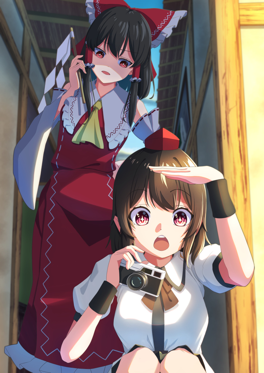 2girls :o amanoyayuki arm_up ascot bare_shoulders black_hair black_ribbon black_skirt bow bright_pupils camera collared_shirt collared_vest commentary_request detached_sleeves feet_out_of_frame frilled_bow frilled_hair_tubes frills gohei hair_bow hair_tubes hakurei_reimu hand_up hat highres holding holding_camera holding_gohei long_sleeves looking_ahead looking_at_another medium_hair multiple_girls open_mouth outdoors pointy_ears red_bow red_eyes red_hat red_skirt red_vest ribbon shameimaru_aya shirt short_sleeves sidelocks skirt skirt_set sparkling_eyes squatting standing tokin_hat touhou vest white_pupils white_shirt white_sleeves wide_sleeves yellow_ascot