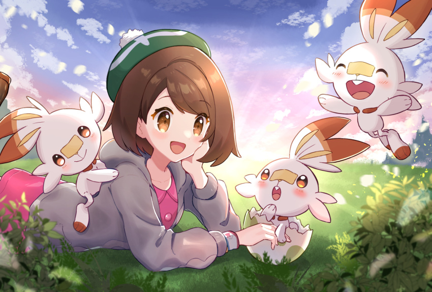 1girl :d bangs blush bob_cut brown_eyes brown_hair cardigan cloud collared_dress commentary_request day dress dynamax_band eggshell gloria_(pokemon) grass green_headwear grey_cardigan haru_(haruxxe) hat hatching highres hooded_cardigan lying on_stomach open_mouth outdoors pink_dress pokemon pokemon_(creature) pokemon_(game) pokemon_swsh scorbunny short_hair sky smile tam_o'_shanter tongue