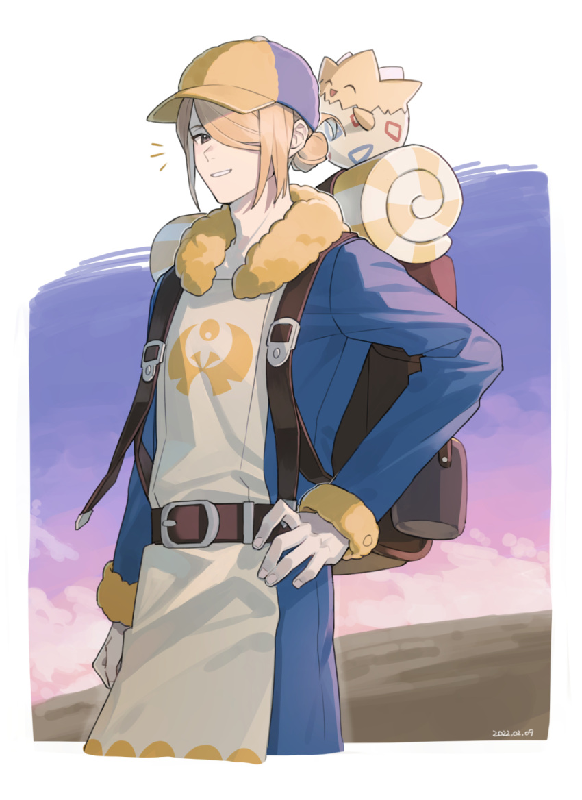 1boy arm_at_side backpack bag blonde_hair blue_jumpsuit border brown_bag commentary_request dated hair_bun hair_over_one_eye hand_on_hip hat highres jumpsuit long_sleeves male_focus notice_lines pankona_(ubsssss) parted_lips pokemon pokemon_(creature) pokemon_(game) pokemon_legends:_arceus smile togepi volo_(pokemon) white_border yellow_headwear