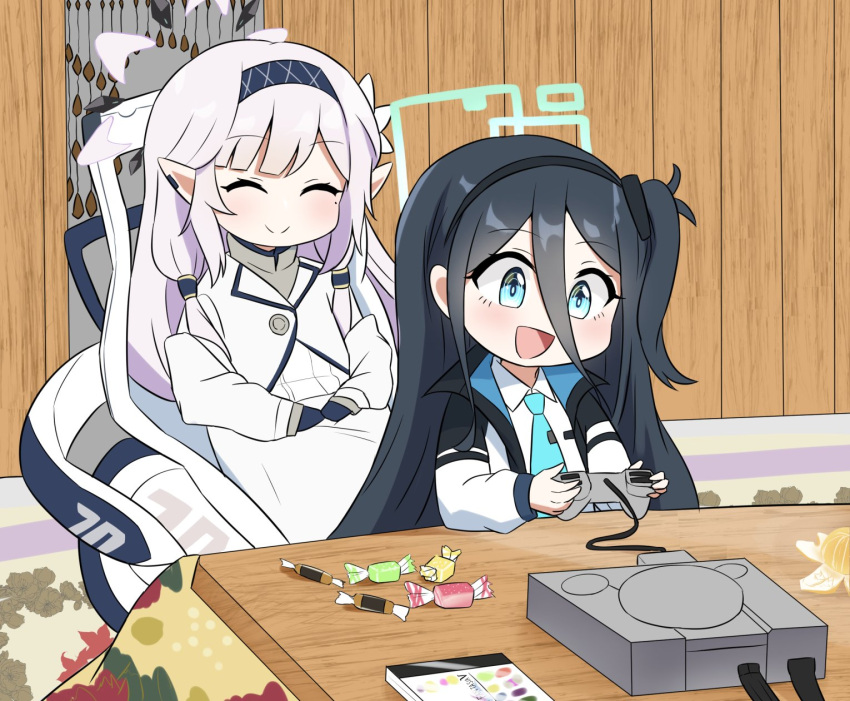2girls aris_(blue_archive) black_hair black_hairband blue_archive blue_eyes blue_necktie candy closed_eyes closed_mouth collared_shirt controller food game_console game_controller grey_hair hair_between_eyes hairband halo highres himari_(blue_archive) holding holding_controller holding_game_controller indoors jacket long_hair long_sleeves mole mole_under_eye multiple_girls necktie open_mouth playstation pointy_ears powered_wheelchair shirt sitting smile thershr6s wheelchair white_jacket white_shirt