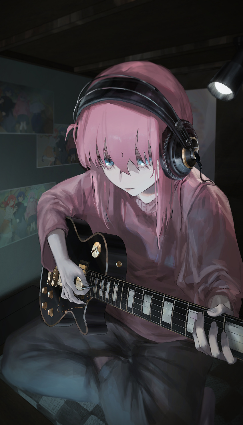 1girl absurdres aqua_eyes bangs black_pants bocchi_the_rock! dark_room electric_guitar gotou_hitori guitar headphones highres holding holding_instrument indoors instrument light_frown long_hair long_sleeves looking_up painting_(object) pants pink_hair pink_shirt rsef shirt sidelocks sitting solo spotlight