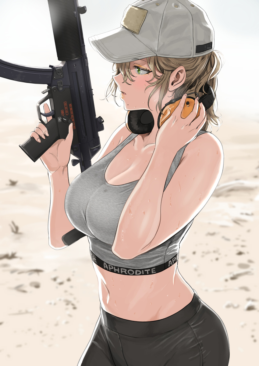 1girl bangs bare_arms bare_shoulders baseball_cap black_pants blurry blurry_background breasts cleavage commentary day english_commentary finger_on_trigger from_side green_eyes grey_headwear grey_sports_bra gun h&amp;k_mp5 hair_between_eyes hand_on_headphones hands_up hat headphones headphones_around_neck highres holding holding_gun holding_weapon large_breasts lips looking_to_the_side midriff mole mole_under_mouth navel original outdoors pants parted_lips profile sand short_hair sidelocks solo sports_bra stomach submachine_gun sweat text_print tsurui weapon