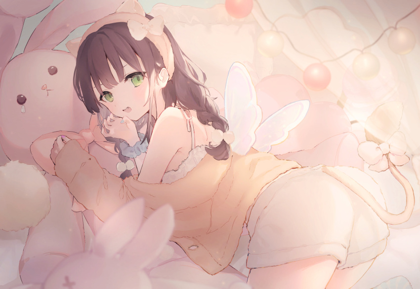 1girl :d animal_ear_headwear back bangs bare_shoulders bed blue_nails braid brown_hair bunny_pillow fingernails green_eyes headband highres indoors long_hair looking_at_viewer loungewear lying original pillow scrunchie shorts sleeves_past_wrists smile solo stuffed_animal stuffed_toy suzumori_uina tail teeth twin_braids upper_body upper_teeth_only wings wrist_scrunchie