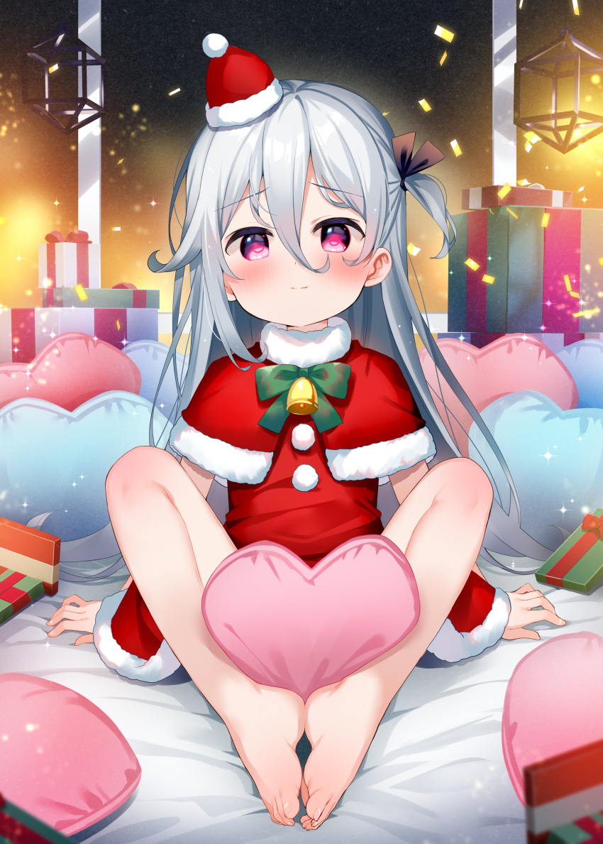 1girl absurdres bangs bare_legs barefoot bell black_ribbon bow box capelet christmas closed_mouth commentary dress feet fur-trimmed_capelet fur-trimmed_dress fur-trimmed_headwear fur_trim gift gift_box green_bow grey_hair hair_between_eyes hair_ribbon hat heart heart_pillow highres long_hair looking_at_viewer meito_(maze) mini_hat mini_santa_hat neck_bell no_shoes one_side_up original pillow purple_eyes red_capelet red_dress red_headwear ribbon santa_costume santa_hat sitting solo symbol-only_commentary tilted_headwear toes very_long_hair