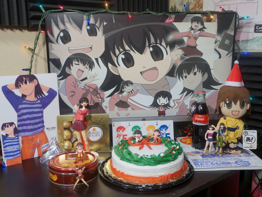 1girl 2d_dating azumanga_daioh azumanga_daioh's_school_uniform blue_shirt cake card christmas christmas_cake christmas_lights coca-cola english_text ferrero_rocher figure food highres japanese_clothes kimono long_sleeves orange_pants pants photo_(medium) playing_card school_uniform shirt shrine soda_bottle solo stuffed_toy takino_tomo yellow_kimono