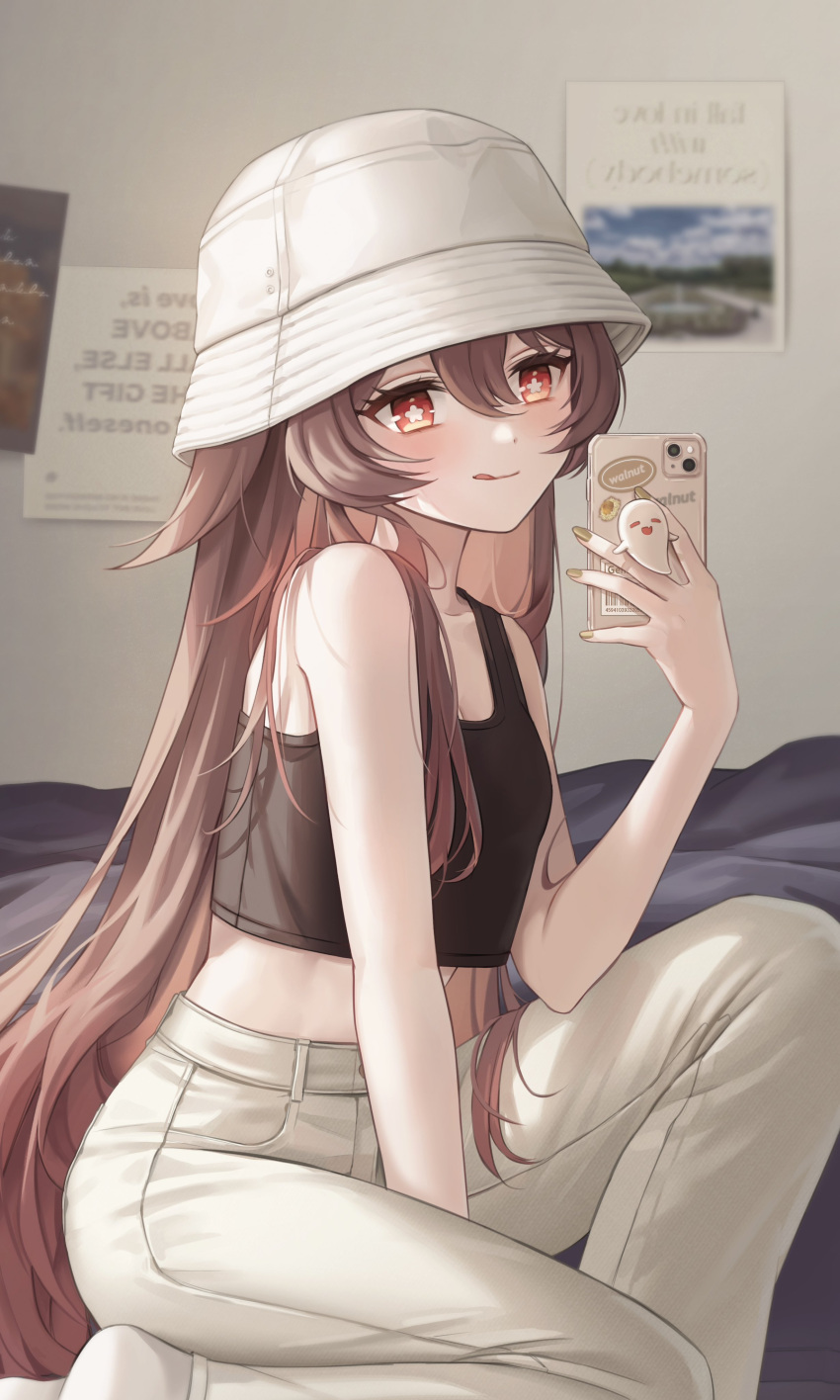 1girl :q absurdres alternate_costume bangs bare_arms bare_shoulders between_legs black_tank_top blush boo_tao_(genshin_impact) breasts brown_hair bucket_hat cellphone contemporary crop_top crop_top_overhang denim feet_out_of_frame flower-shaped_pupils genshin_impact hair_between_eyes hand_between_legs hand_up hat highres holding holding_phone hu_tao_(genshin_impact) indoors jeans knee_up long_hair looking_at_viewer midriff miho_(mymiho) nail_polish one_knee pants phone pocket red_eyes selfie sidelocks small_breasts smartphone solo symbol-shaped_pupils tank_top tongue tongue_out twintails very_long_hair white_headwear white_pants yellow_nails