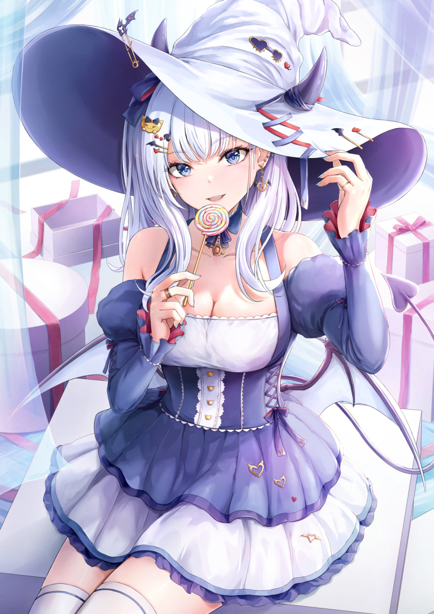 1girl aqua_nails blue_eyes box breasts candy cleavage demon_tail demon_wings dress earrings food gift gift_box hair_ornament hat highres holding holding_candy holding_food horns horns_through_headwear jewelry long_hair long_sleeves looking_at_viewer low_wings medium_breasts open_mouth original ring short_dress sitting solo tail teeth thighhighs tokeshi upper_teeth_only white_hair white_headwear white_thighhighs wings witch_hat
