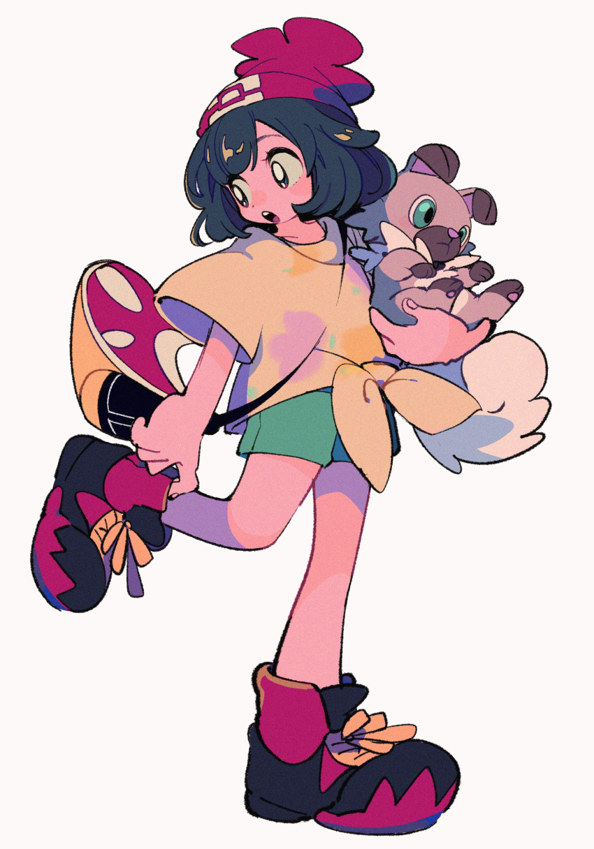 1girl :o absurdres bag bangs beanie black_hair boots commentary_request floral_print green_shorts hat highres holding holding_pokemon leg_up looking_back ok_ko19 open_mouth pokemon pokemon_(creature) pokemon_(game) pokemon_sm rockruff selene_(pokemon) shirt short_shorts short_sleeves shorts shoulder_bag simple_background standing standing_on_one_leg t-shirt teeth tied_shirt tongue upper_teeth_only white_background yellow_shirt