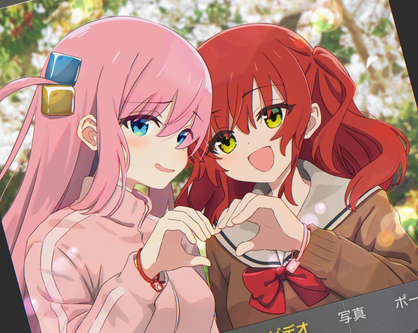 2girls blue_eyes blurry blurry_background bocchi_the_rock! bow bowtie bracelet brown_cardigan cardigan commentary_request cube_hair_ornament day dutch_angle gotoh_hitori green_eyes hair_between_eyes hair_ornament hand_up heart heart_hands heart_hands_duo highres jacket jewelry kita_ikuyo krill55 lens_flare long_hair long_sleeves looking_at_viewer multiple_girls one_side_up open_mouth outdoors pink_hair pink_jacket red_bow red_bowtie red_hair sailor_collar school_uniform shuka_high_school_uniform smile track_jacket upper_body white_sailor_collar yuri