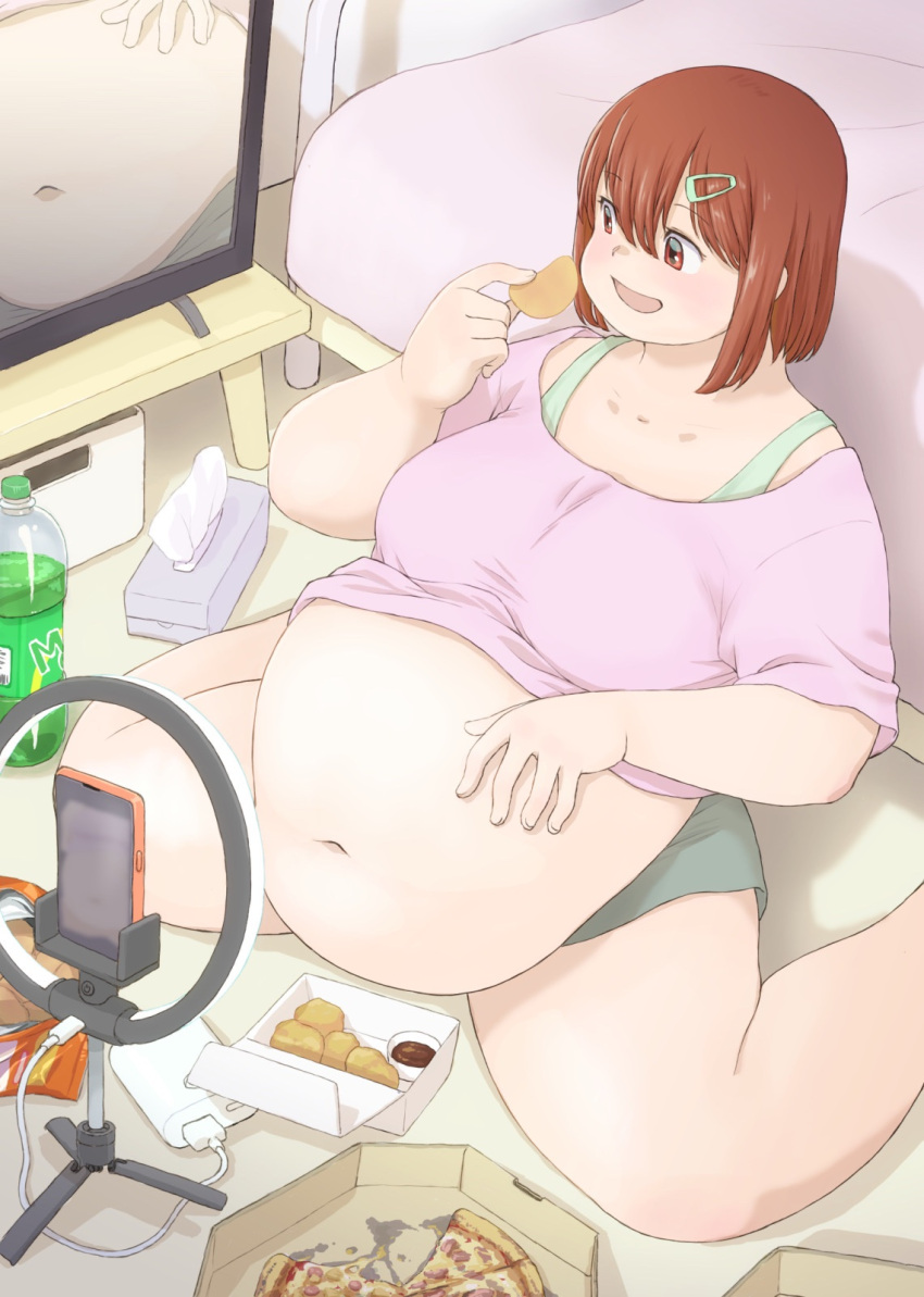 1girl bed big_belly blush box brown_eyes brown_hair cellphone chips_(food) collarbone commentary_request eating fat food foot_out_of_frame hair_between_eyes hair_ornament hairclip highres holding holding_food indoors katou_(katohayabusa) looking_at_screen medium_hair navel on_floor open_mouth original packet phone pizza pizza_box power_bank ring_light shadow short_sleeves sidelocks sitting smartphone soda_bottle solo table tareme television thick_arms thick_thighs thighs tissue_box wariza